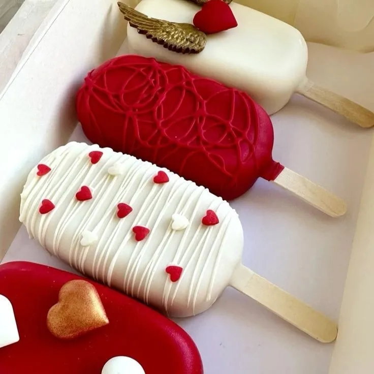 Variedad de paletas de chocolate con diseños románticos.